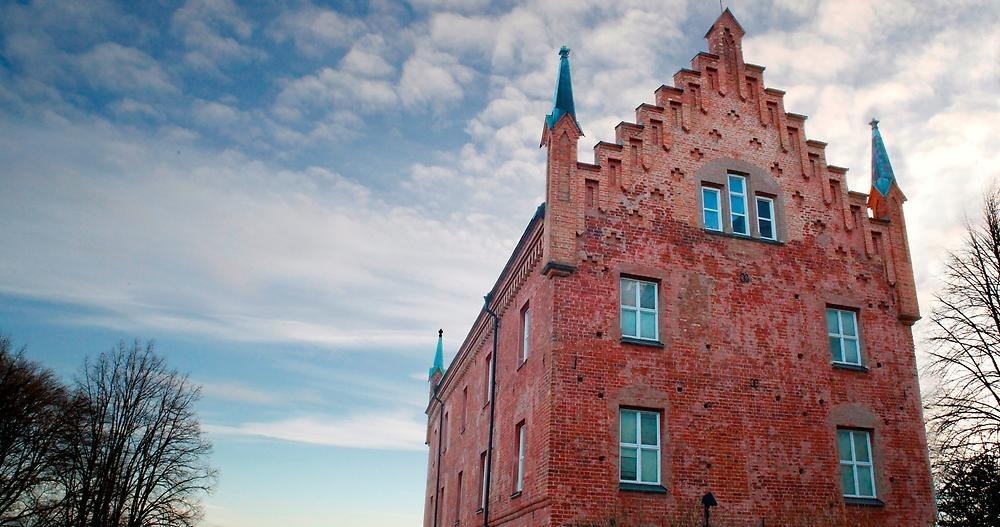 The Rogge Library, an old castle-like brick house.