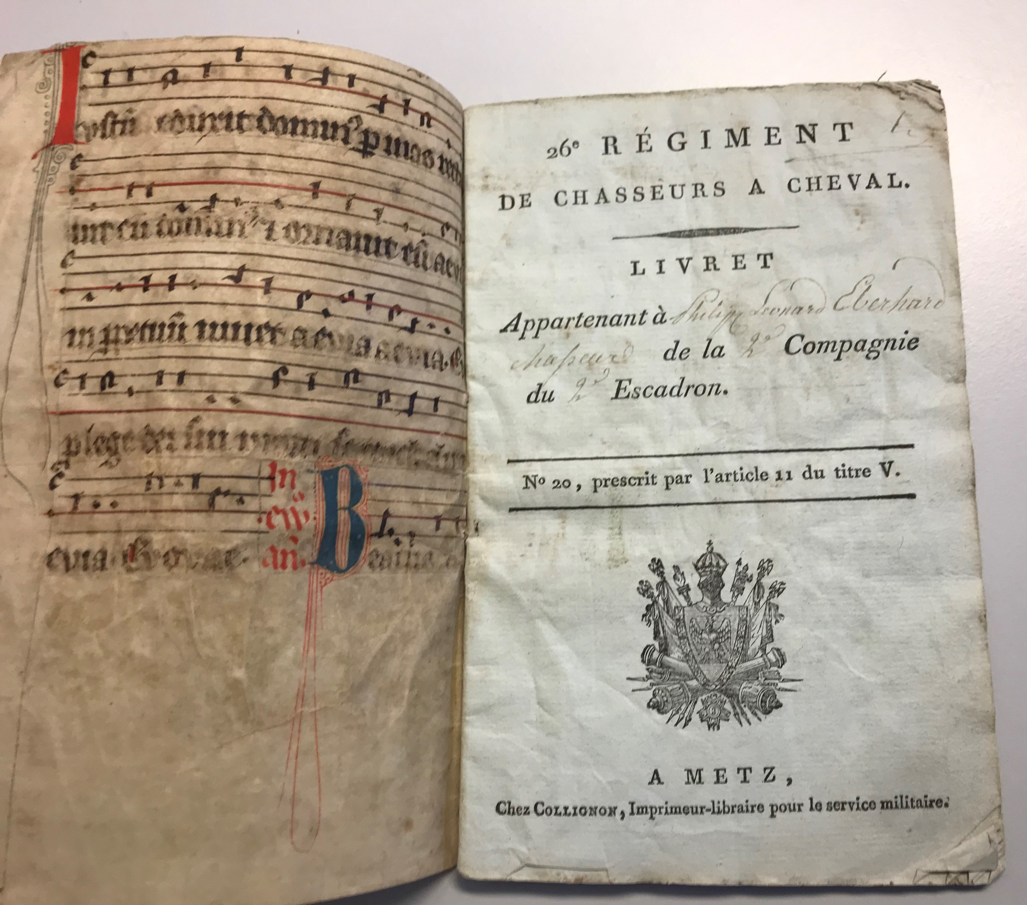 En uppslagen tryckt bok från 1700-talet inbunden i en medeltida handskrift.