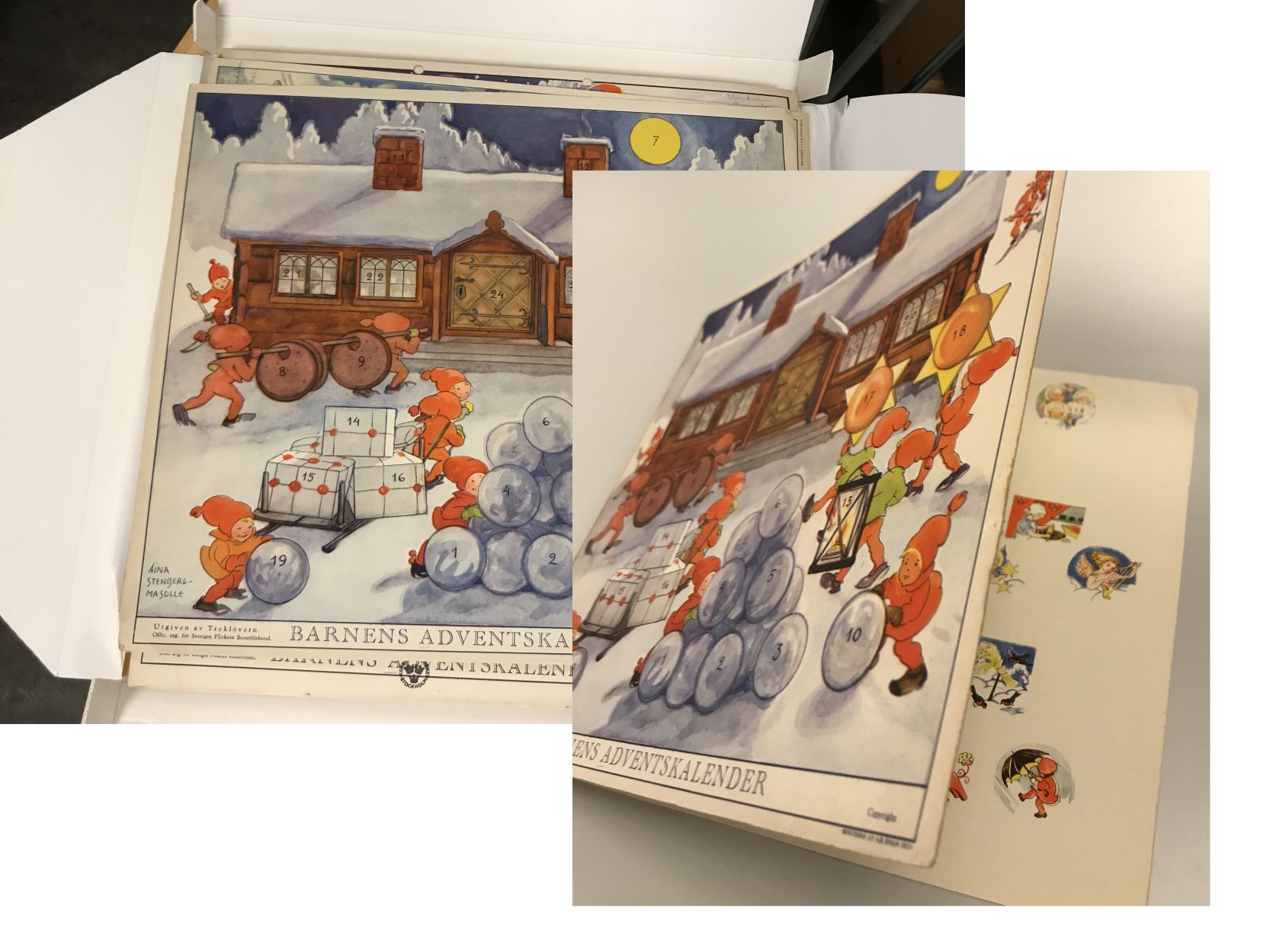 Barnens julkalender 1934 - framsidan med tomtenissar i ett snöigt landskap framför ett timmerhus samt en glimt av kalenderns insida där bilderna bakom luckeona syns