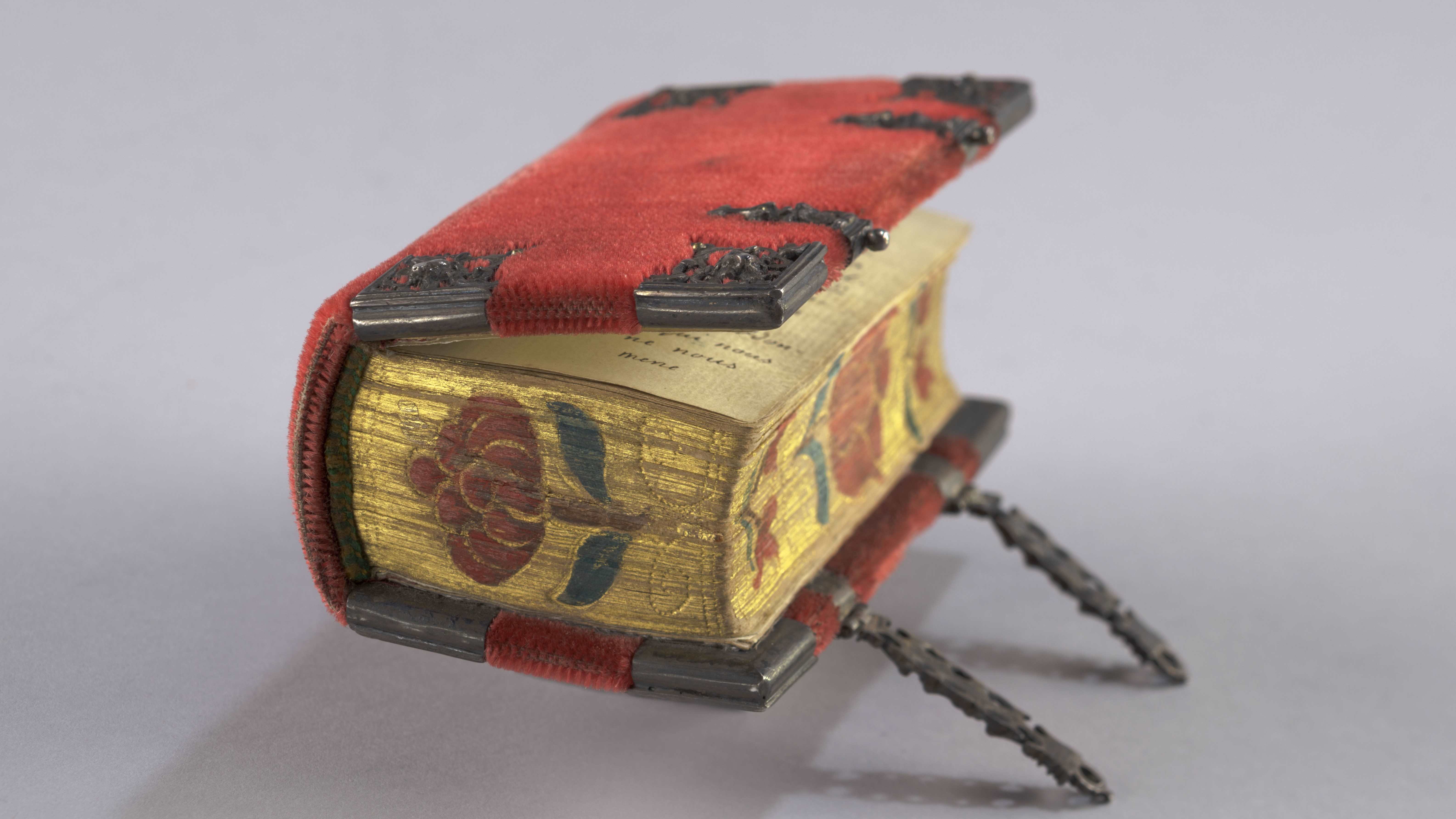 Hymnal with red velvet binding with chased gilt edges decorated with floral motifs.