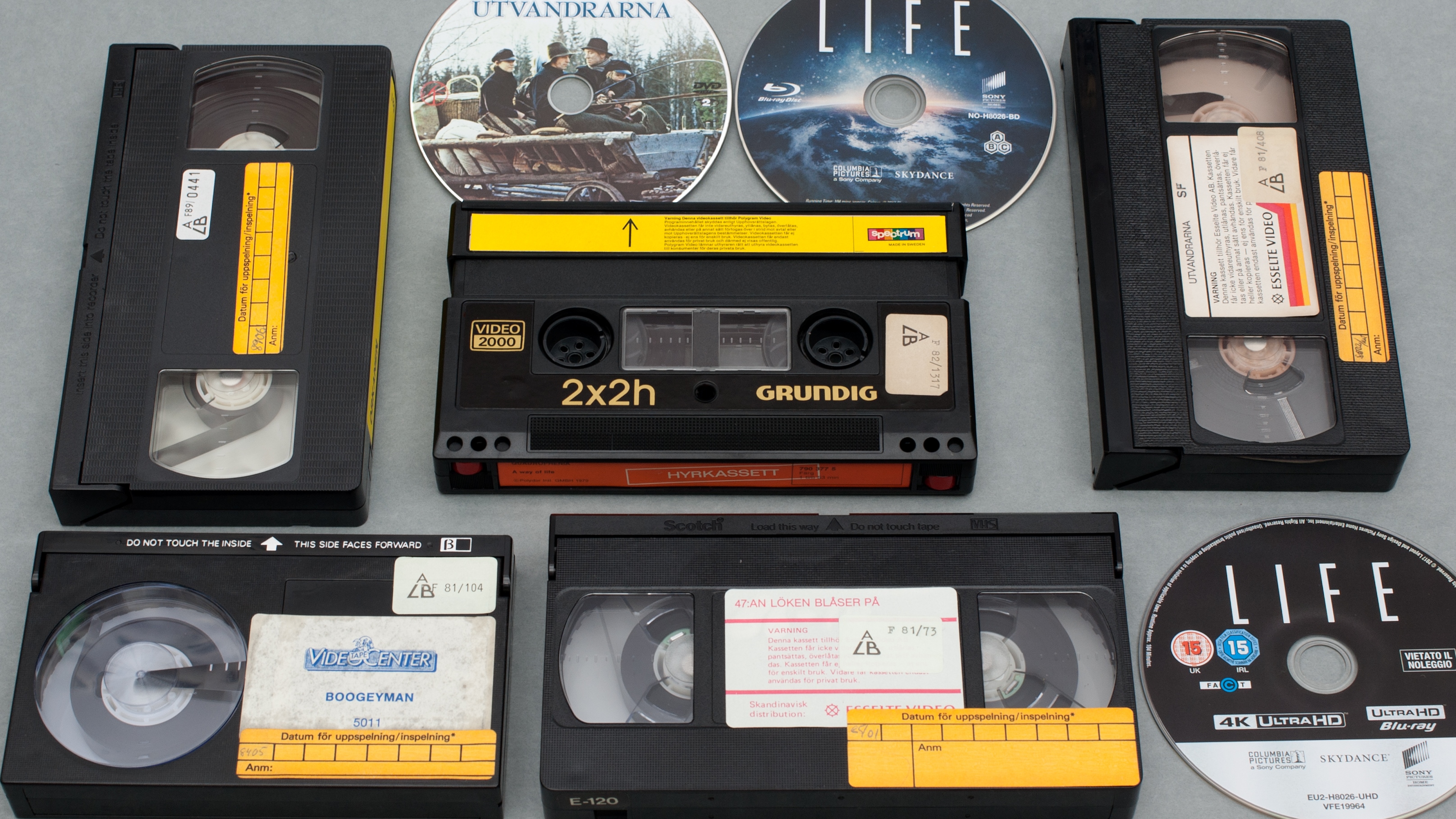 A collection of VHS tapes and CDs.