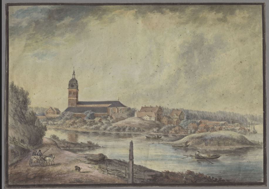 Vy över en stad som ligger vid en sjö, på en kulle syns en stor kyrka