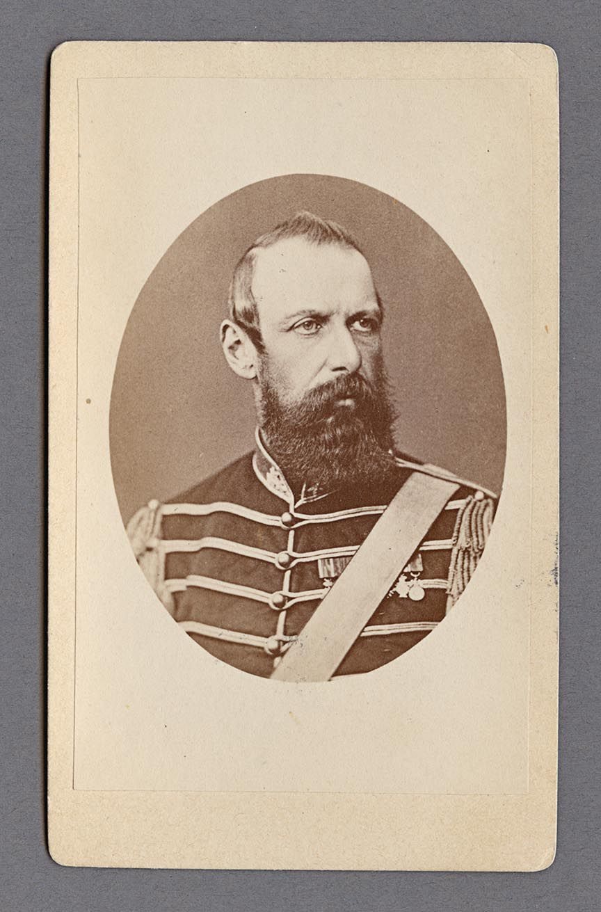 Bystporträtt av kung Karl XV iklädd uniform med ordensband och med ett välansat helskägg. Hans tittar åt vänster, vilket gör att höger öra är synligt.