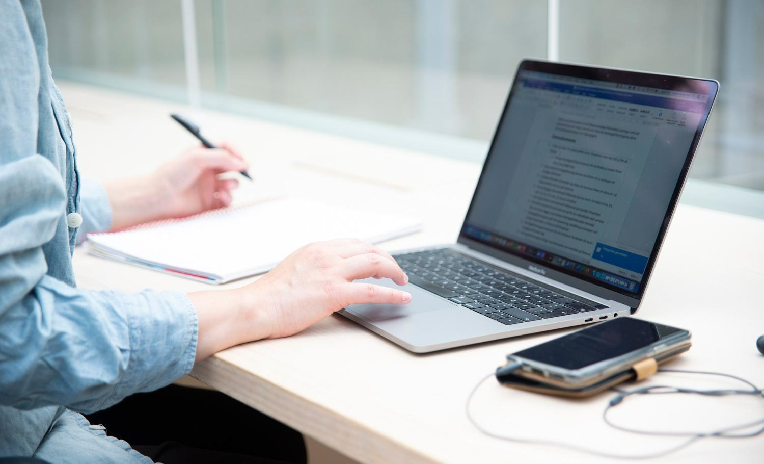 A person working in front of a laptop computer.