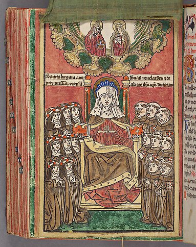 En nunna sitter på en hög stol omgiven av munkar och nunnor. Ovanför hennes huvud syns Jesus och Maria på en infälld bild.