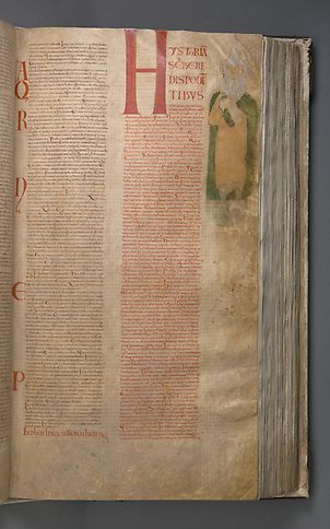 En sida i en bok med text och en bild av en gubbe med skägg och grön mantel i marginalen.