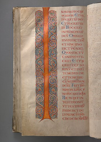 A book page with the letter I and colorful ornamentation.