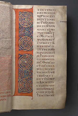 A book page with the letter E and colorful ornamentation.