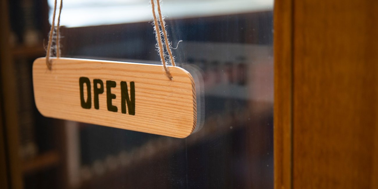 A wooden sign with the text "open".