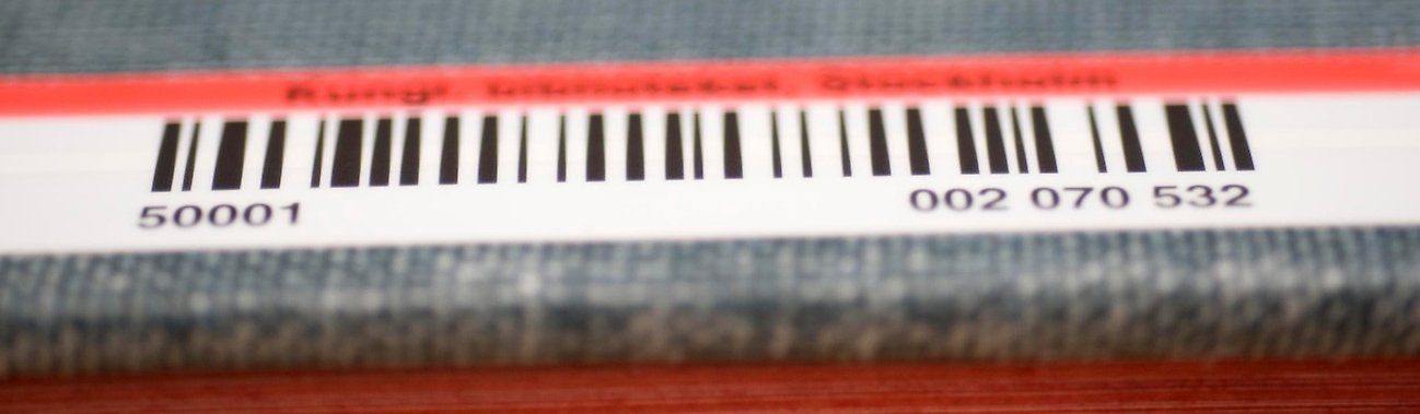 A close-up of a barcode and ISBN number on a book.