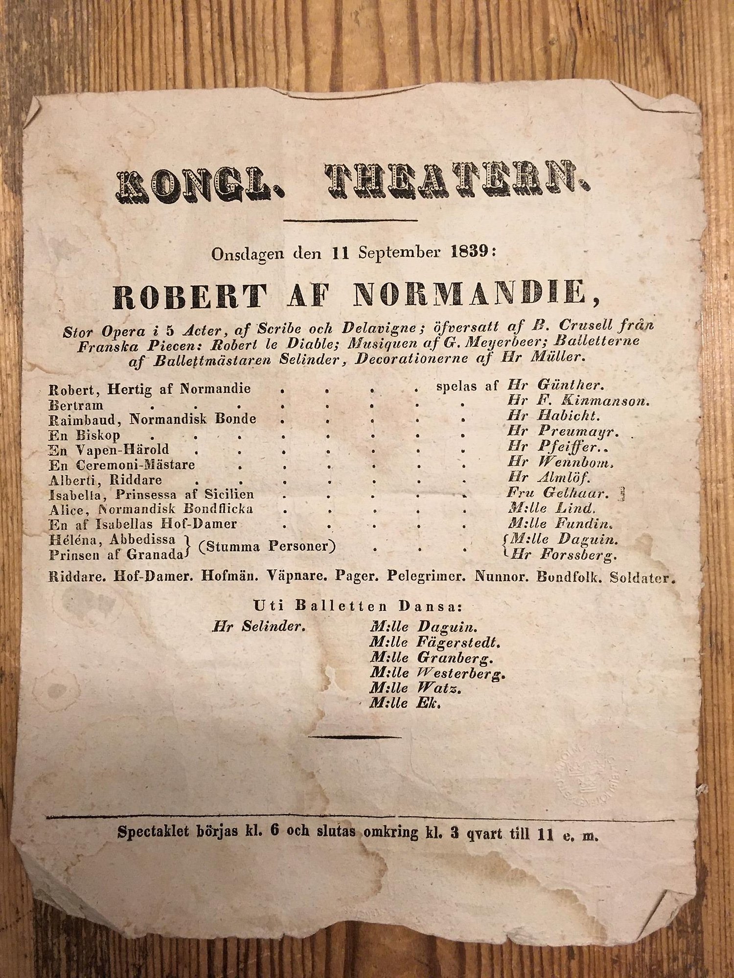 Affisch med rollista över medverkande i en opera.